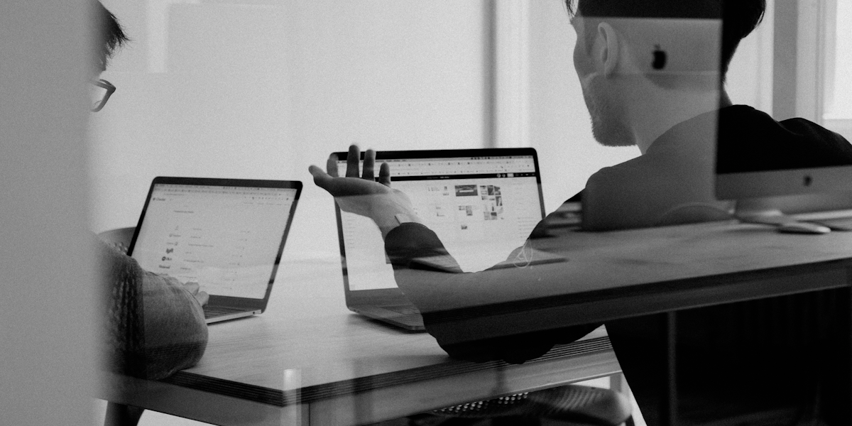 Person presenting data on a large screen to a small team